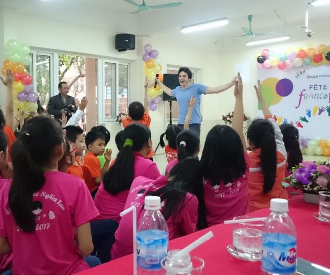 A participant from the Westpoint University volunteer group speaks to Vietnamese students in Asia. A student from Westpoint University gives a presentation to children in Vietnam during his group volunteer trip.